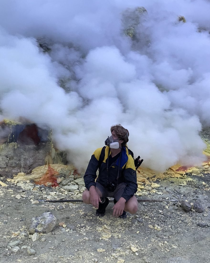 Brandon crouching beside volcanic steam