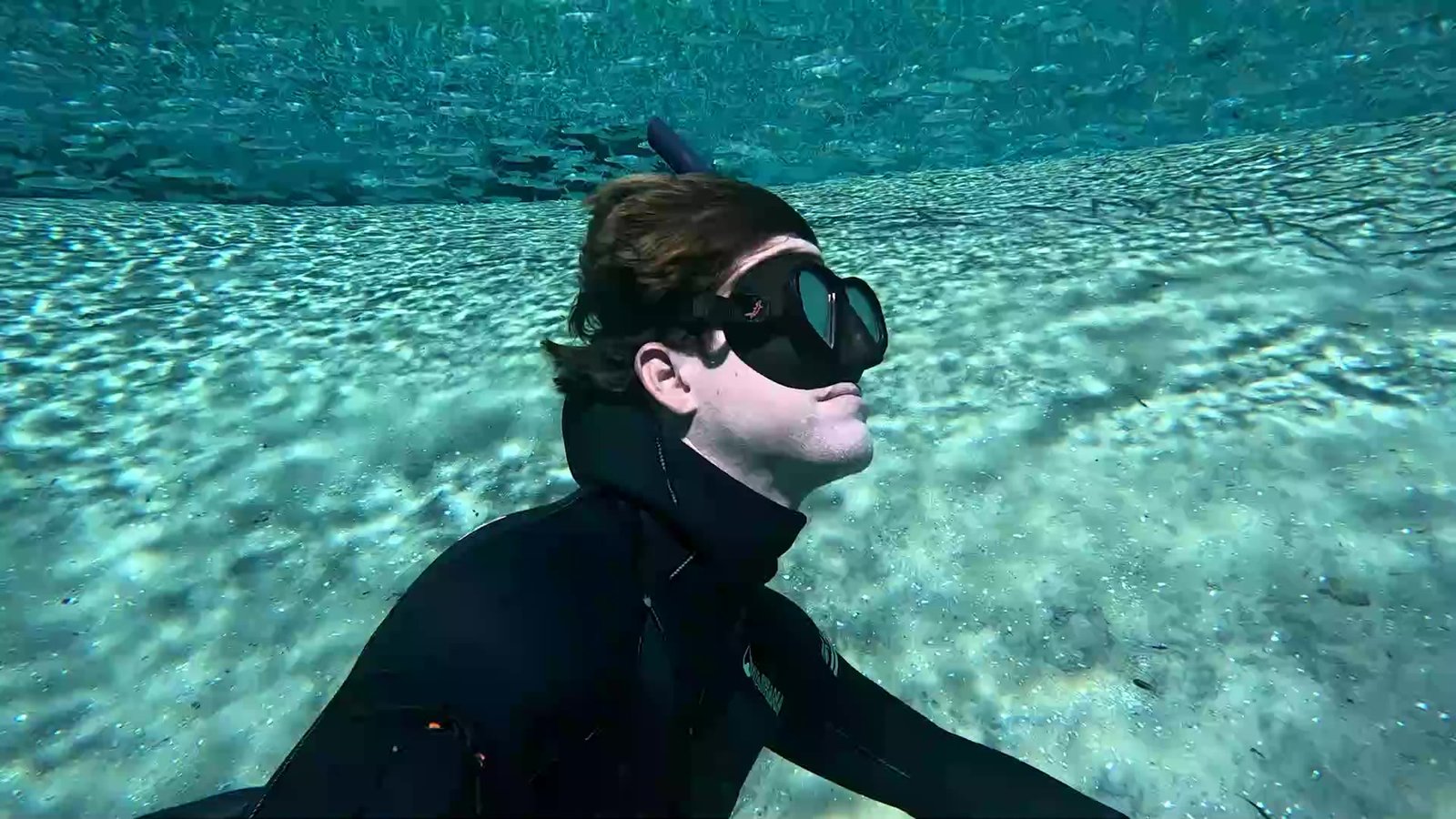 Freediving over white sand in a Florida spring